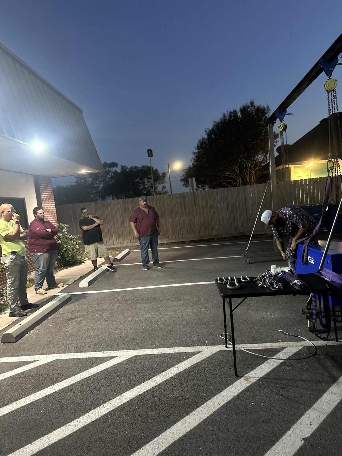 Students watching an outdoor rigging equipment demonstration in Portland